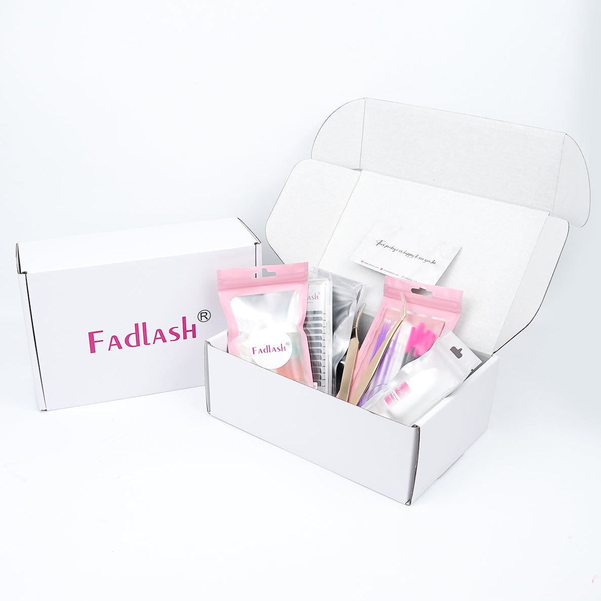 Full eyelash extension starter bundle with premium gold tweezers on pink background.