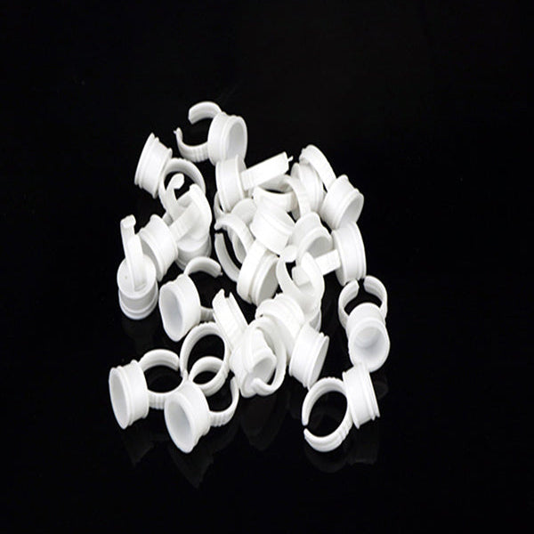 Disposable glue ring worn on finger holding lash adhesive during application